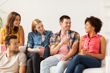 Image showing happy friends with popcorn and beer at home