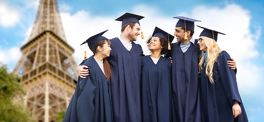 Image showing happy students or bachelors over eiffel tower