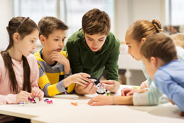 Image showing happy children building robots at robotics school