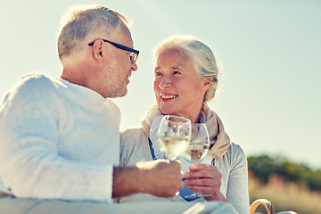 Image showing happy senior couple having picnic on summer beach