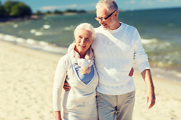 Image showing happy senior couple hugging on summer beach