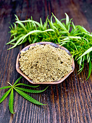 Image showing Flour hemp in clay bowl with green leaf on board