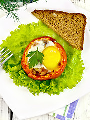 Image showing Scrambled eggs in tomato on board top