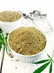 Image showing Flour hemp and grain in bowls with leaf on board