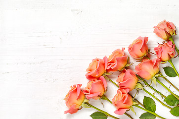 Image showing pink roses on white wood background