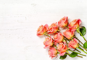 Image showing pink roses on white wood background