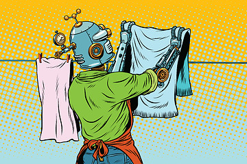 Image showing Vintage robot employee hangs up to dry clothes