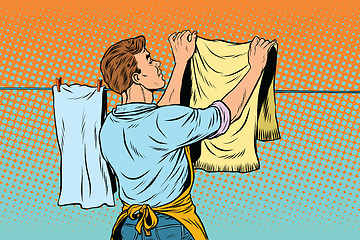 Image showing Vintage employee hangs up to dry clothes