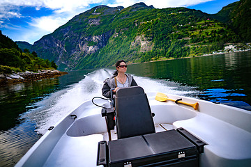 Image showing Woman driving a motor boat