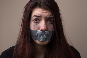 Image showing Crying brunette with gray tape