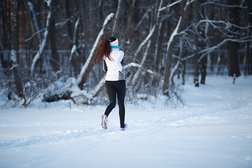 Image showing Young girl running among trees