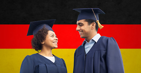 Image showing happy students or bachelors in mortar boards