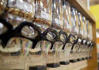 Image showing row of jars with nuts and seeds at grocery store