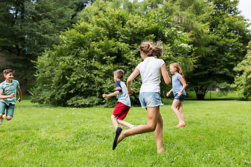 Image showing group of happy kids or friends playing outdoors