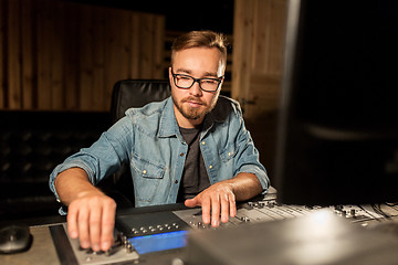 Image showing man at mixing console in music recording studio