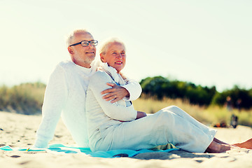 Image showing happy senior couple hugging on summer beach