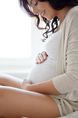 Image showing close up of happy pregnant woman in bed at home