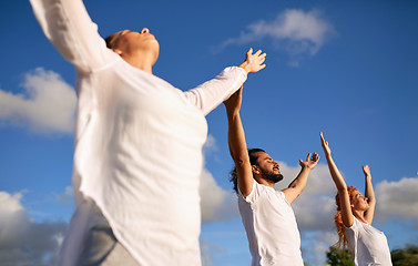 Image showing group of people making yoga or meditating outdoors