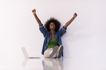 Image showing african american woman sitting on floor with laptop