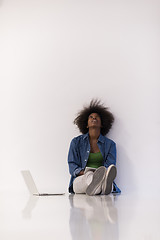 Image showing african american woman sitting on floor with laptop