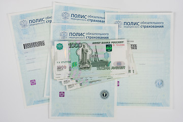 Image showing Russian money is on the policy of compulsory medical insurance, white background