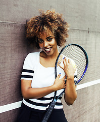 Image showing young stylish mulatto afro-american girl playing tennis, sport h