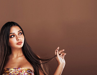 Image showing cute happy young indian woman in studio close up smiling, fashion mulatto