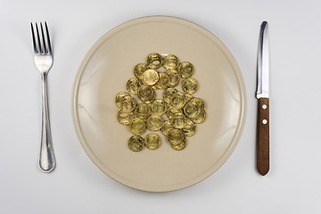 Image showing On the plate is a bunch of Russian ten-coin lying near tableware view from above