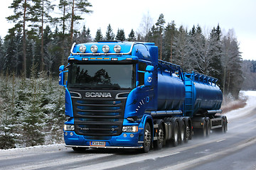 Image showing Blue Scania R580 Tank Truck Hauling on Rural Winter Highway