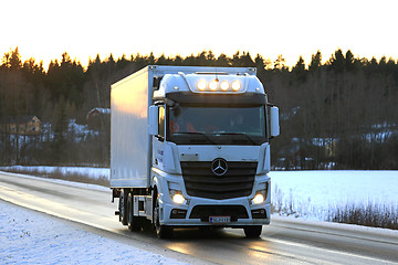 Image showing White Mercedes-Benz Actros Trucking at Sunset