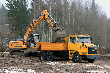 Image showing Liebherr Crawler Excavator Loads Sisu SR332 Tip Lorry