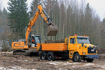 Image showing Crawler Excavator Loads Sisu Tipper Truck