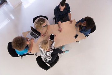 Image showing Multiethnic startup business team on meeting  top view