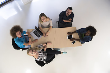 Image showing Multiethnic startup business team on meeting  top view