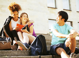 Image showing cute group of teenages at the building of university with books huggings, back to school