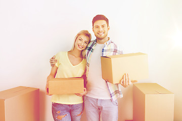 Image showing smiling couple with big boxes moving to new home