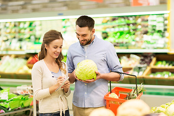 Image showing couple with food basket shopping at grocery store