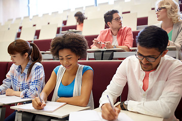 Image showing group of students with notebooks in lecture hall