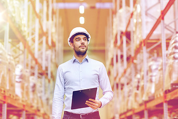 Image showing happy businessman with clipboard at warehouse