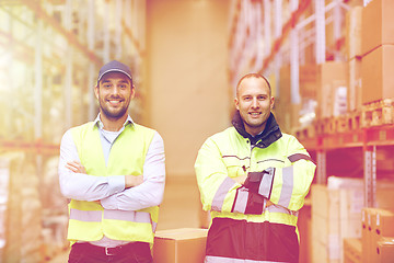 Image showing men in uniform with boxes at warehouse