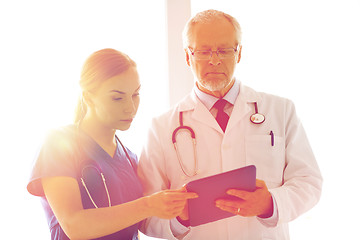 Image showing senior doctor and nurse with tablet pc at hospital