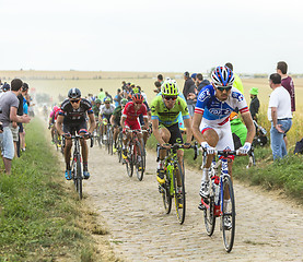 Image showing The Peloton on a Cobblestone Road - Tour de France 2015