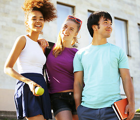 Image showing cute group of teenages at the building of university with books huggings, back to school