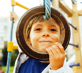 Image showing little cute boy hanging on gymnastic ring