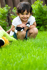 Image showing Playing outside with her toys