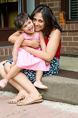 Image showing Mother and daughter sitting at the doorstep