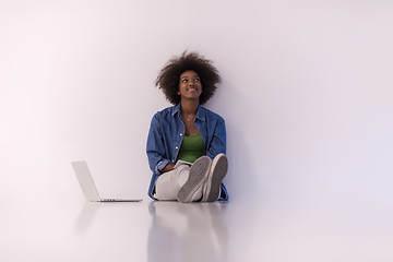 Image showing african american woman sitting on floor with laptop