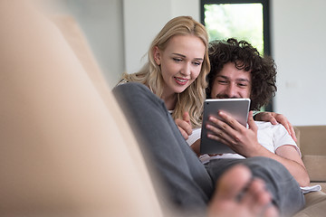 Image showing couple relaxing at  home with tablet computers