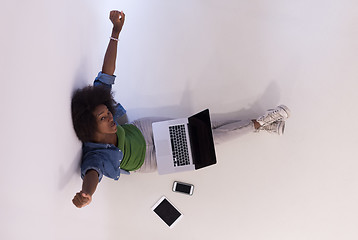 Image showing african american woman sitting on floor with laptop top view