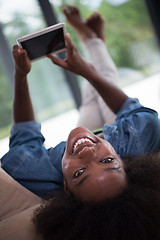 Image showing african american woman at home with digital tablet